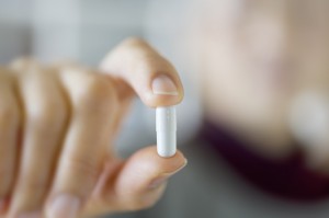 Woman holding capsule